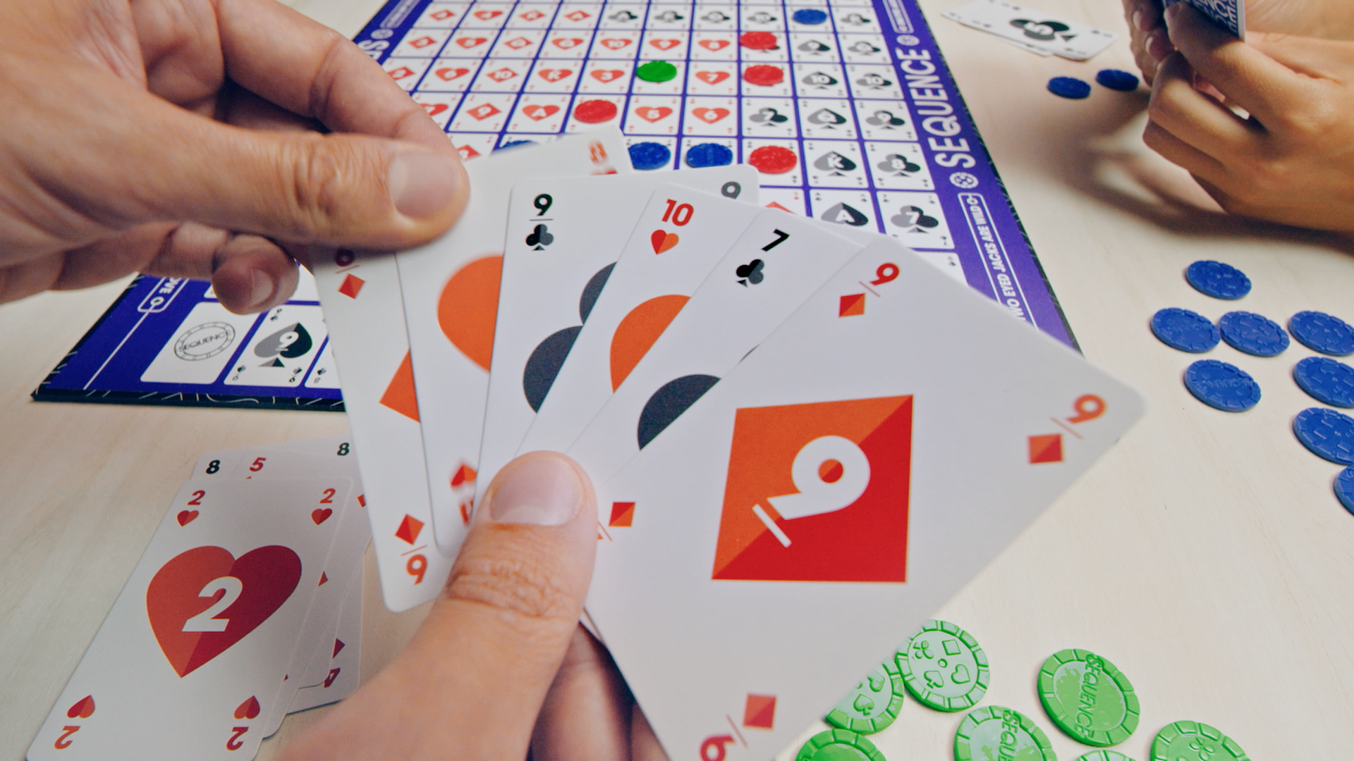 Mensen die het strategische bordspel Sequence spelen